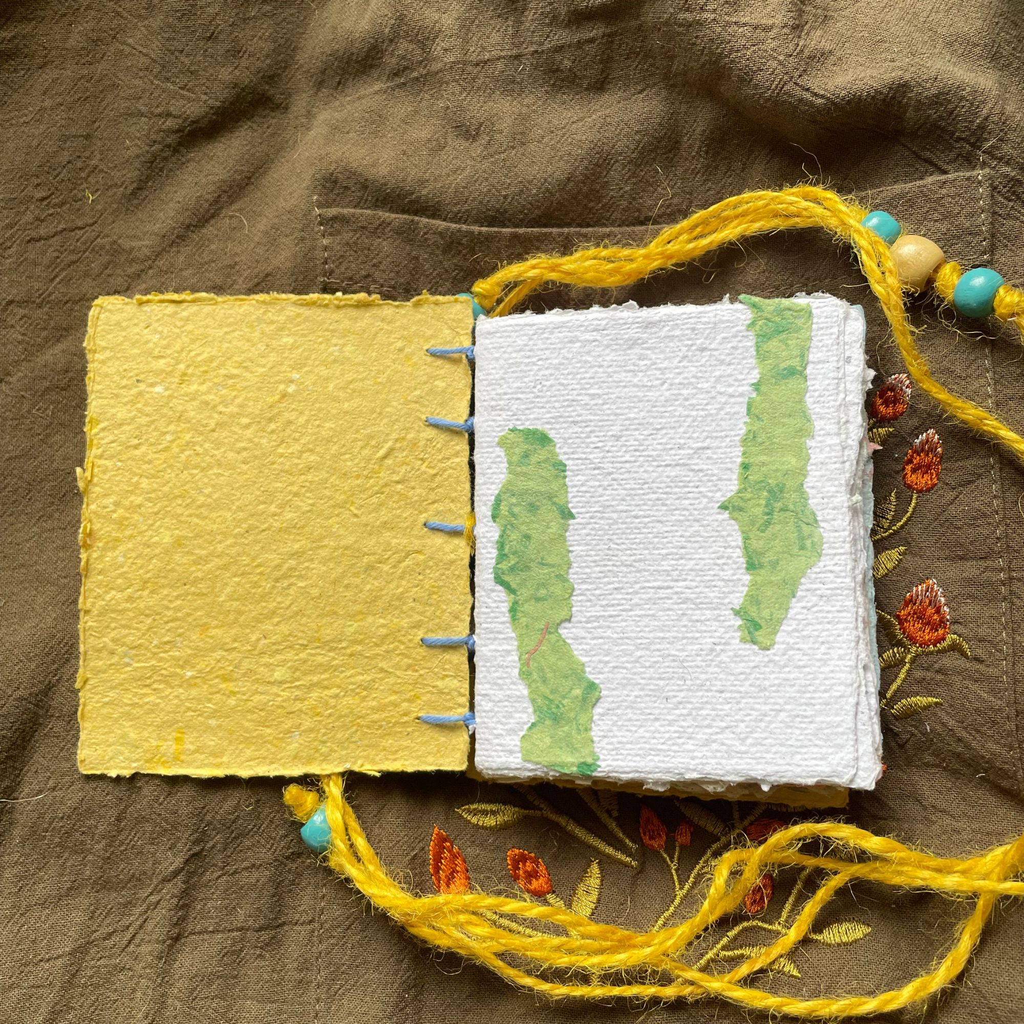 Daybreak handmade paper pocket journal opened to show tactile handmade pages