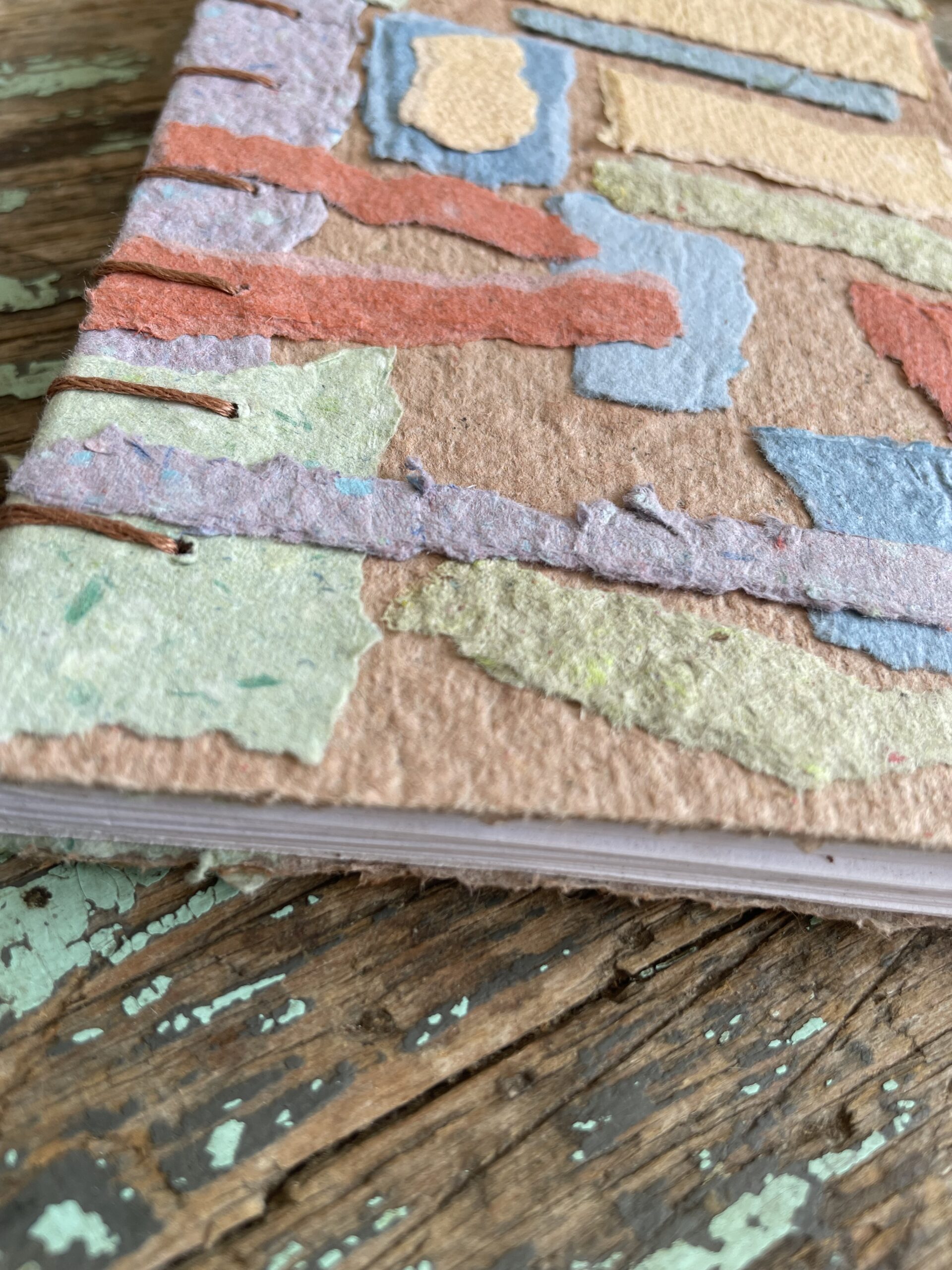 Close up of texture on Sea Glass handmade paper collage notebook with Coptic binding